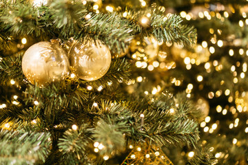 Obraz na płótnie Canvas detailed view of golden balls on christmas tree with branches