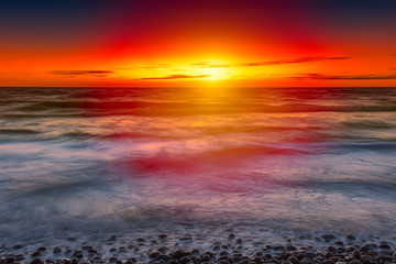 Fototapeta na wymiar Dramatic red sunset in the Baltic sea