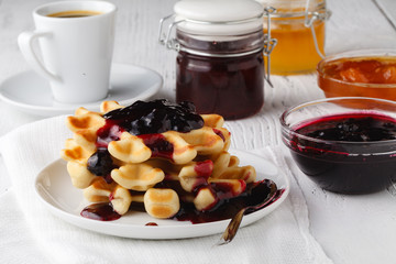 Whole wheat Belgium waffle topped with boysenberry syrup