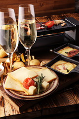 Delicious traditional Swiss melted raclette cheese on diced boiled or baked potato served in individual skillets.
