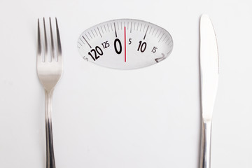 Naklejka premium scale with cover and knife, concept of diet and lose weight