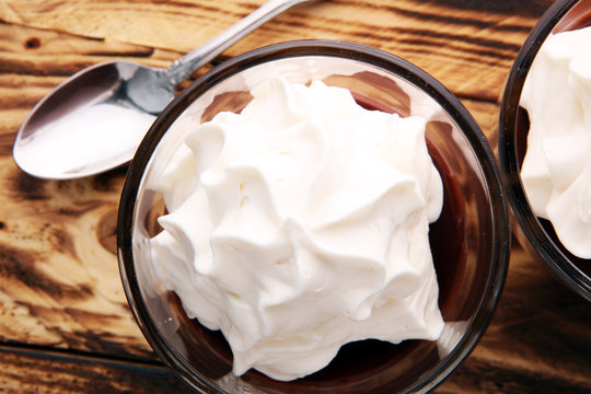 Hot chocolate or coffee with whipped cream in glass.