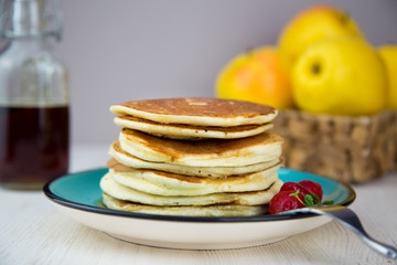 Canadian breakfast pancakes with strawberries and mint