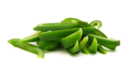 sliced green bell pepper in a bowl on white background