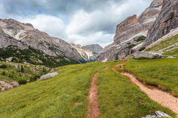 Fototapeta na wymiar Path in wild Travenanzes valley with Vallon Bianco and Nemesis Mounts background, Dolomites, Italy