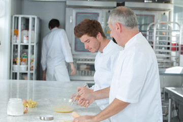 chef teaching trainee how to become a pastry chef