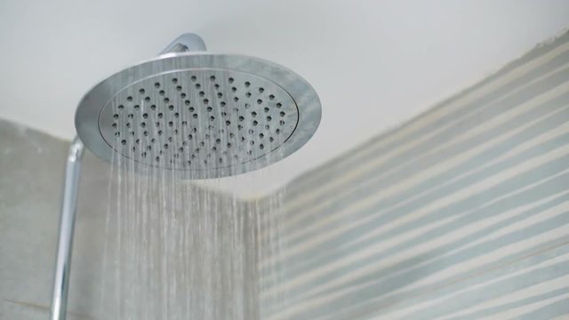 Home shower head closeup, raindrop flow model, spilling water
