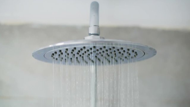 Home shower head closeup, raindrop flow model, spilling water