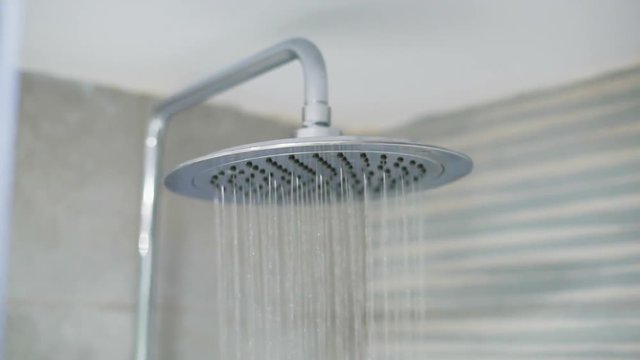 Home shower head closeup, raindrop flow model, spilling water