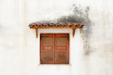 Traditional vintage window closed stunami and tiled roof