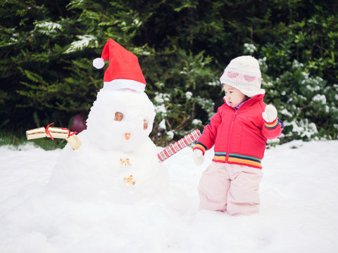 Baby Girl Play With  Christmas Snowman