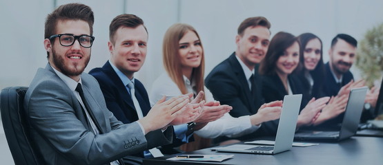 Photo of happy business people applauding at conference