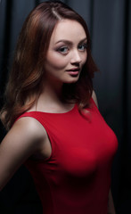 Fashionable young beautiful woman in a red dress