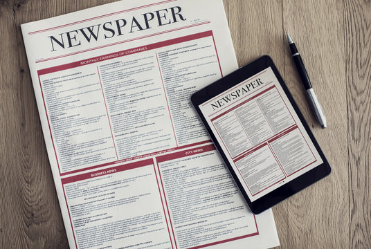 Newspaper with digital tablet on wooden background