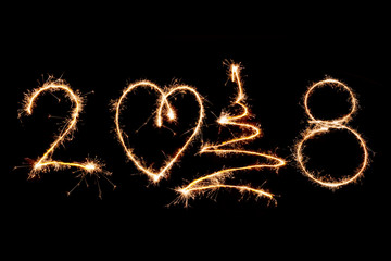 2018 written with Sparkle firework on black background, happy new year 2018 concept