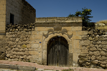 OId door in a wall with bricks in the South Cappadocia Valley.