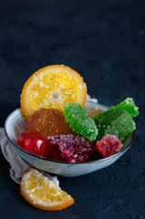 Fruit crystallized in a bowl on a dark background.