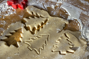 The process of making ginger cookies, slabs of dough. Cookies in the shape of a Christmas tree.