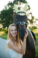 Obraz premium Beautiful young woman with horse outdoor on a walk in nature