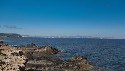 View of the port of Ibiza from the rocky beach