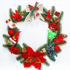 Fototapeta na wymiar Christmas wreath with decorations, branch of Xmas tree on white background. A symbol of winter and new year holidays. Free space