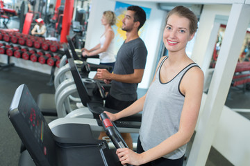young people training on exercise bikes in gym