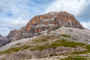 Vertical and majestic western side of Tofana di Rozes and Castelletto Peaks with boulders at the...