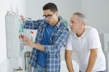 Obraz premium workers installing device on the wall