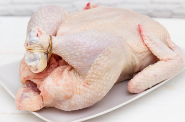 Raw chicken on white table