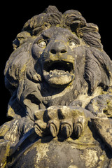 old sculpture of a snarling growling lion