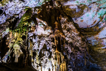 Postojna cave, Slovenia. Formations inside cave with stalactites and stalagmites. Low light image.
