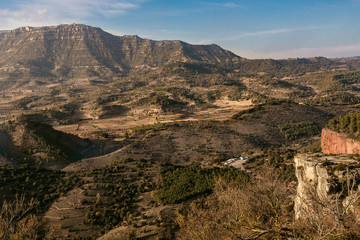 Fototapeta na wymiar Great tall and beautiful mountains for climbing in a surreal place in Siurana, Spain.
