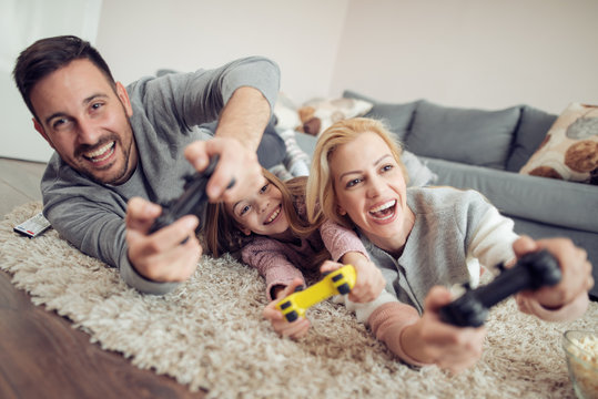 Happy Family Playing A Video Games At Home