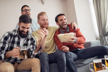 Fotobehang Group of friends watching football game together © ivanko80