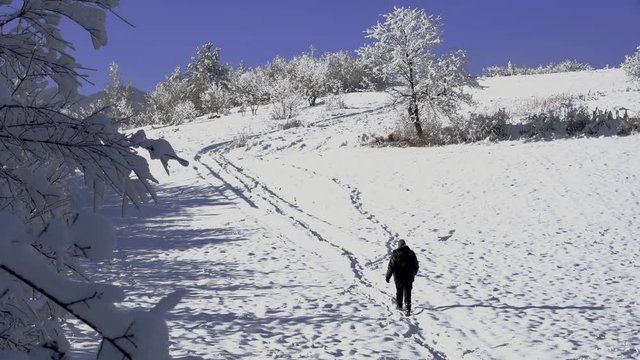 Man goes from path in depth snow - (4K)