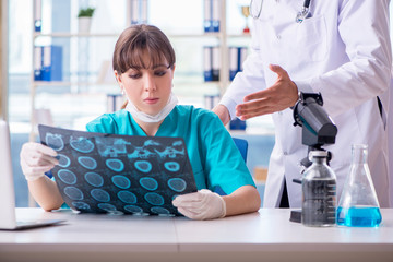 Two doctors discussing x-ray MRI image in hospital