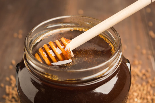 Closeup view of buckwheat honey with spoon