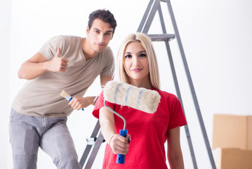 Young family doing painting job during home renovation