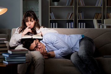 Two students studying late preparing for exams