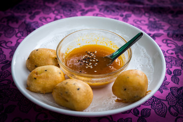 Banana with powder deep fried with syrup sesame sauce in a bowl, Food of Thailand