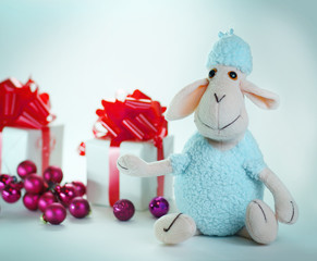Christmas gifts and a toy sheep .isolated on white background