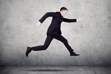 Young businessman running with fast motion