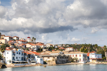 Obraz premium View over the bay with crystal clear water and typical houses in Koroni, Messinia, Greece 