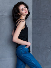 Portrait of slim young Caucasian woman turning back to camera smiling and looking flirty