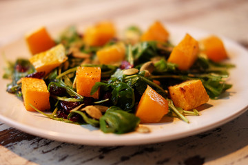 salad with pumpkin, pumpkin seeds and arugula