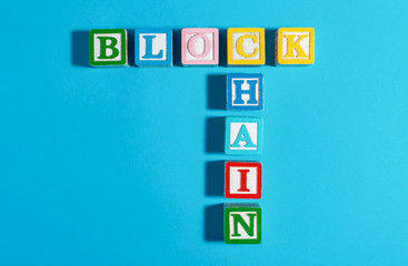 Blockchain concept with toy blocks on a blue background