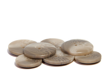 Single brown clothing button isolated over the white background