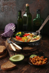 Farfalle pasta with slices of grilled chicken, sweet peppers, avocado, cabbage, broccoli, tomatoes and red cabbage