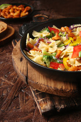 Farfalle pasta with slices of grilled chicken, sweet peppers, avocado, cabbage, broccoli, tomatoes and red cabbage