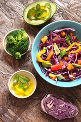 Salad of red cabbage, pieces of grilled chicken, sweet peppers, avocado, tomato